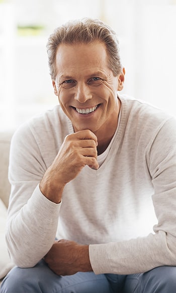 A man with dental implants smiling