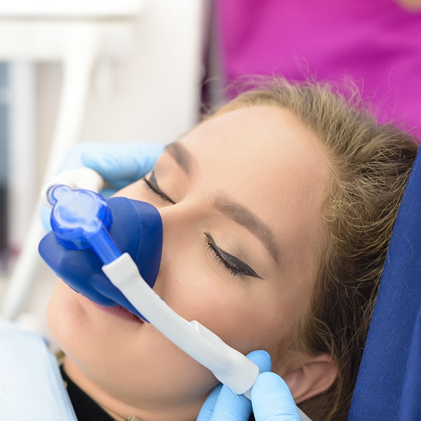 A young woman being sedated with nitrous oxide