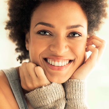 A woman with dental veneers smiling