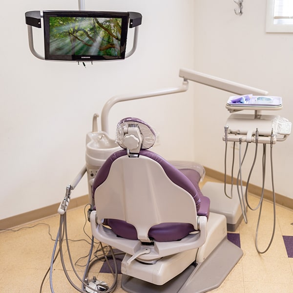 Our comfortable surgery room with a TV above the dental chair