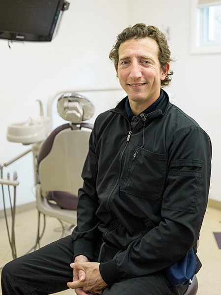 Jimmy our hygienist smiling in a treatment room